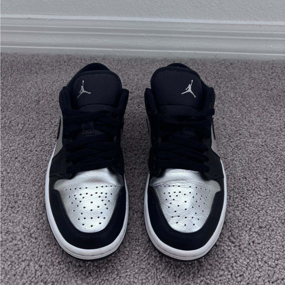 Woman’s Air Jordan 1 low SE Sneakers in Black and Metallic Silver